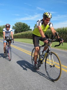 CJ and Clair ride by the tall corn