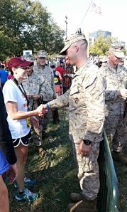 A finisher receives her medal
